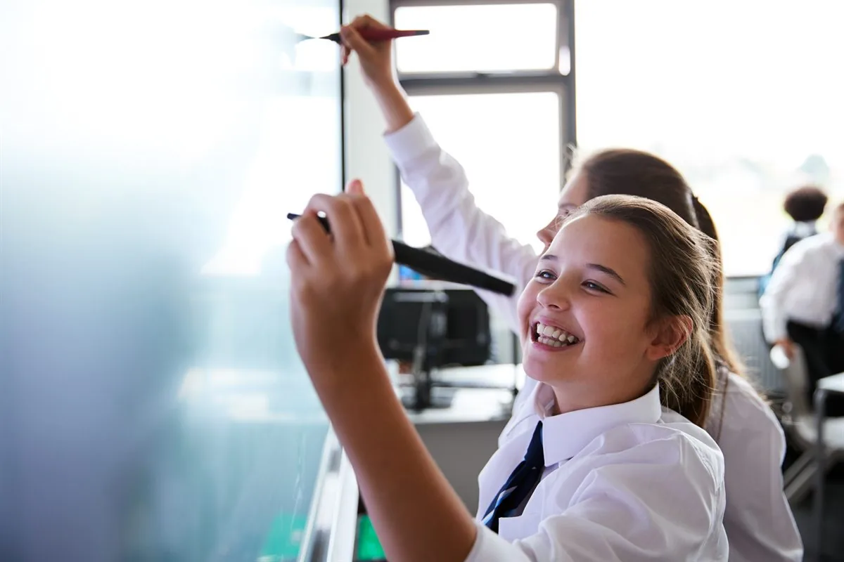 School pupils learning together in class